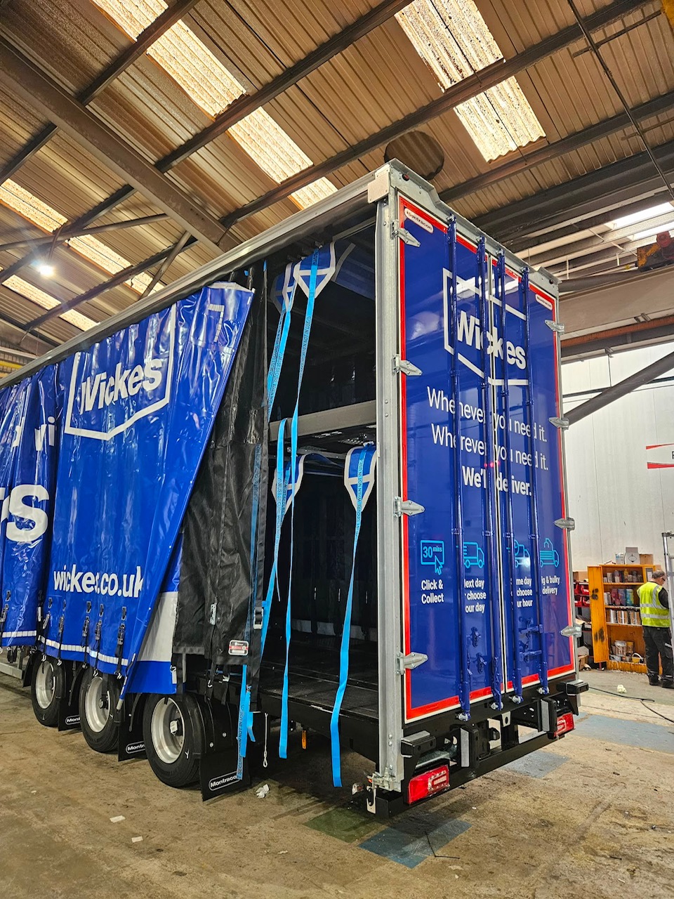 Wickes double-deck curtain sider in a bodybuilder workshop with hanging straps